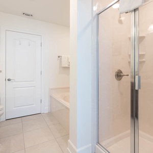 Indulge in relaxation in the master bath with a soothing tub and refreshing shower