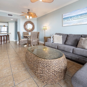 Unwind on the plush sofa with queen sleeper surrounded by coastal décor and stylish dining table with woven chairs