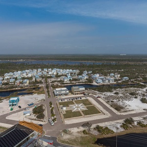 This stunning view showcases a serene landscape with charming blue homes and a peaceful waterway