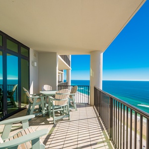 This spacious balcony features comfortable seating and stunning beachfront views, perfect for relaxing or dining outdoors