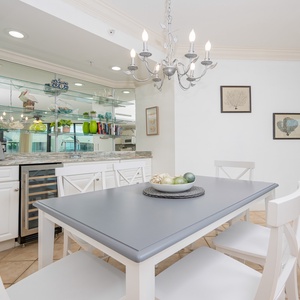 Gather around the stylish table for a delightful evening, surrounded by charming decor and serene ambiance