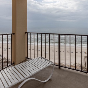 Relax on the private balcony with a serene view of the serene beach and gentle waves, perfect for unwinding