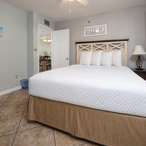 Cozy guest bedroom featuring a plush queen bed, soft linens, and a welcoming ambiance, perfect for a restful getaway