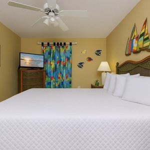 Enjoy a restful night in this guest bedroom, where soft queen bedding and coastal decor create a serene vibe