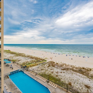 Enjoy the refreshing poolside view, with the beach and water just steps away for a perfect day of relaxation
