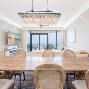 Dine in style at the elegant table, surrounded by comfortable chairs and stunning beach view