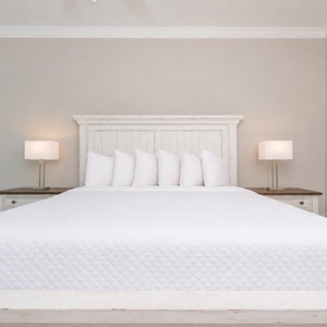 Retreat to the serene guest bedroom featuring a king bed and soft decor for restful nights