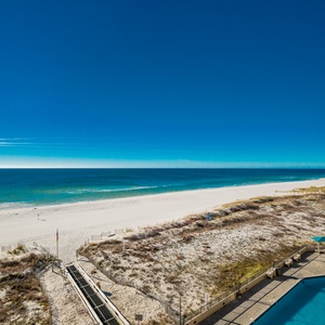 Gaze at the expansive water views while enjoying the inviting pool area just steps away from the beach