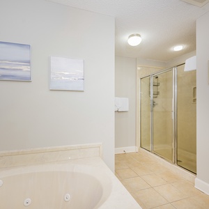 Refresh in the master bath after a day at the beach with a soothing jetted tub and relaxing walk-in shower
