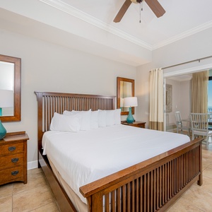 Cozy master bedroom featuring a king bed, elegant decor, and a stunning view through large windows