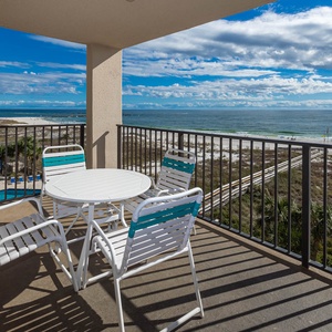 Relax on the balcony enjoying the calming views of the waves and beach