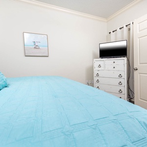 Relax on the cozy king bed in this guest suite and enjoy a movie after a fun vacation day