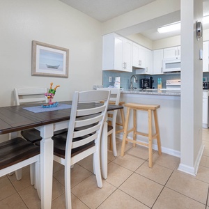 The kitchenand dining area features sleek cabinetry, a table for four, and a cozy atmosphere perfect for family meals