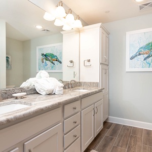 Experience relaxation with plush towels and a refreshing shower in the master bath, perfect for prepping for a beach day
