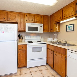 This kitchen features wooden cabinetry and a welcoming atmosphere for preparing meals during your stay