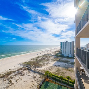 Sunlight sparkles past the balcony as you savor endless beach views stretching into the distance