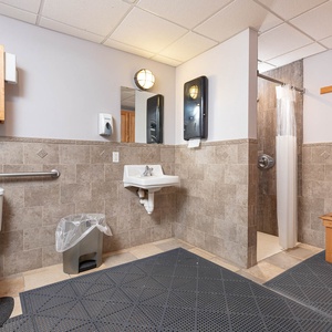 This clean and functional bathroom features a shower, sink, and convenient amenities for a refreshing stay at Seawind