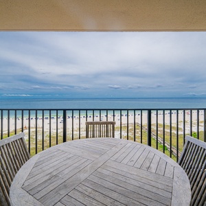 Savor meals while enjoying expansive views of the beach and tranquil waters from your balcony