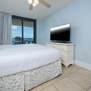 Relax in this tranquil master suite featuring a king bed, a TV, and beach balcony access