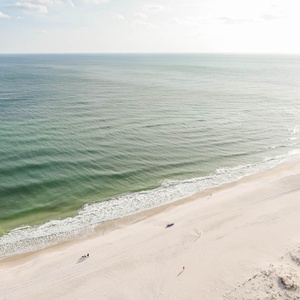 This bright space offers a stunning beachfront view with gentle waves and soft sand, perfect for relaxation and enjoyment