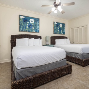 Sleep peacefully in this spacious guest room with two plush queen beds, vibrant artwork, and a cozy vibe