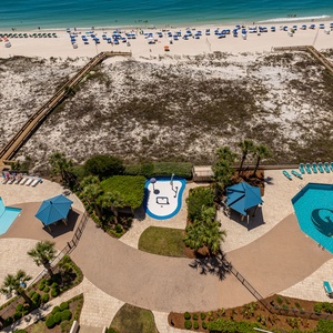 Children splash and play in the colorful pool area ans splash pad while you relax on loungers in the sun