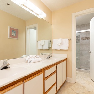 Refresh in this master bathroom featuring dual sinks and a stylish walk-in shower
