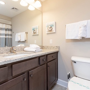 Freshen up in this guest bath in the relaxing shower or soothing tub before an exciting beach day