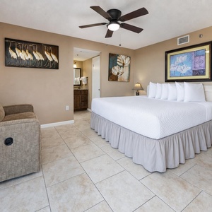 In the king master suite, you rest easily with a cozy couch and warm lamp light nearby