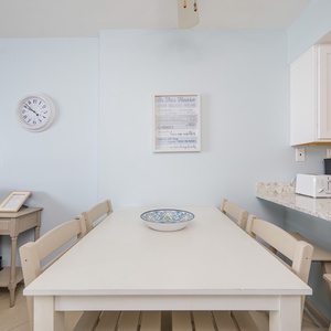 Gather around the cozy dining table for family game nights or casual chats, surrounded by uplifting decor