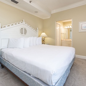Unwind in this guest bedroom featuring a plush king bed, tasteful decor, and a TV for your entertainment