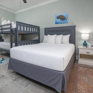 Guests will sleep soundly in this bunk room with a cozy queen bed and double over double bunks