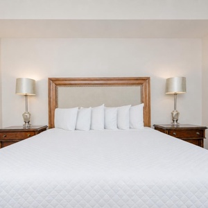 Discover a peaceful slumber in the master bedroom, where soft bedding invites you to relax and recharge for beach adventures