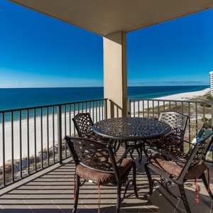 Enjoy meals or drinks at the round table on the balcony while taking in the expansive beach views