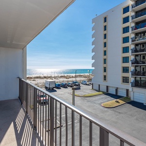 Enjoy a relaxing view from the balcony overlooking the beach, complete with comfortable seating for unwinding