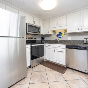 This kitchen features stainless appliances, granite countertops, and a welcoming atmosphere for preparing meals