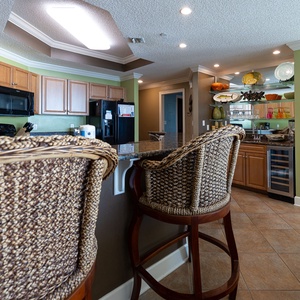 Gather around the inviting bar stools, sipping coffee while enjoying the vibrant decor and a view of the coast