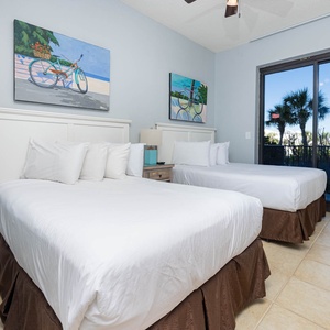 Unwind in this guest bedroom with two double beds, stylish decor, and views of palm trees from the balcony