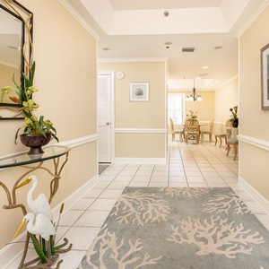 Step into a welcoming entryway adorned with decorative accents, leading to a bright living space