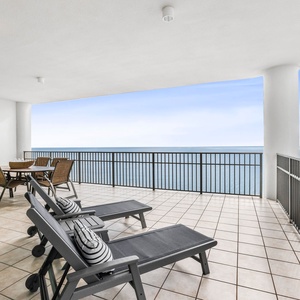 This spacious wrap-around balcony features loungers and a dining set for enjoying beach views from the fourteenth floor