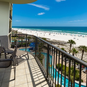 Warm sunlight bathes your balcony as you relax watching waves roll onto the white beach shore below