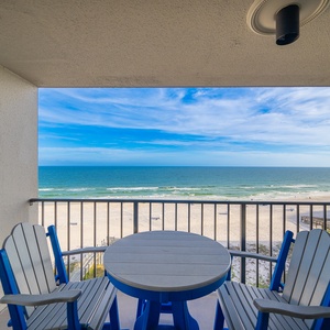 Gentle waves brush the shore beyond your balcony where you gather around the table with loved ones