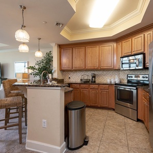 This kitchen features stainless appliances, granite countertops, and a cozy breakfast bar, perfect for morning coffee
