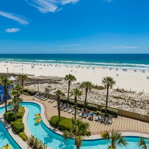 Children's laughter echoes as you watch the colorful waterslide swirl by the winding lazy river near the beach