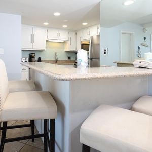 The kitchen features elegant cabinetry, a spacious countertop, and modern appliances, perfect for meal prep
