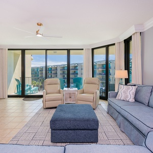 Unwind in the cozy seating area, where bright natural light invites you to relax and enjoy coastal breezes