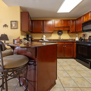 Gather around the stylish bar seating in the kitchen, perfect for casual meals and enjoying the inviting decor