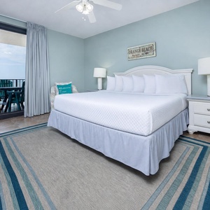 Enjoy restful nights in this inviting master bedroom featuring a plush king bed and balcony access to stunning beach views