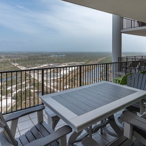 Enjoy breathtaking views from the spacious balcony featuring a stylish outdoor dining set and comfortable seating