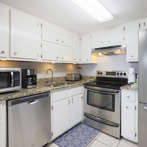 This kitchen features stainless appliances, granite countertops, and a welcoming atmosphere for preparing meals